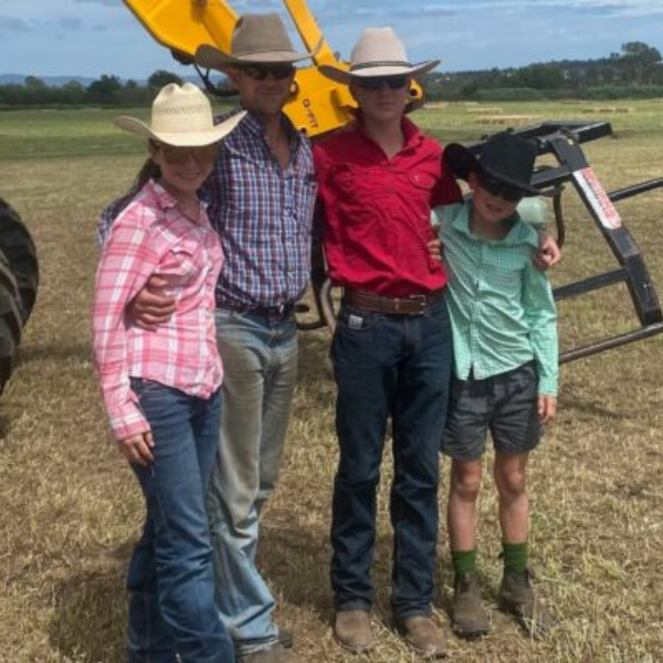 An image of a family standing on a farm - FeedRight Haylage.